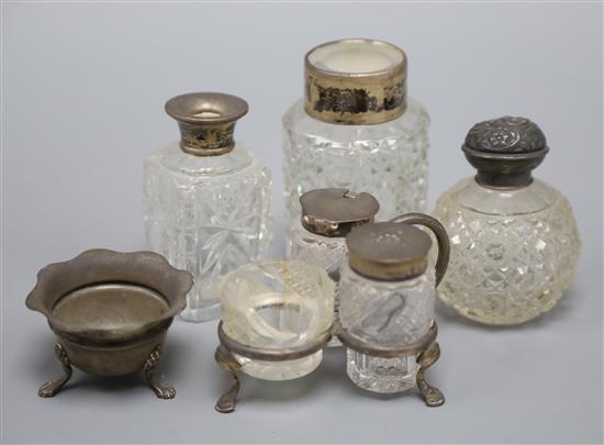 A silver mounted cruet set, a silver salt and three mounted toilet jars.